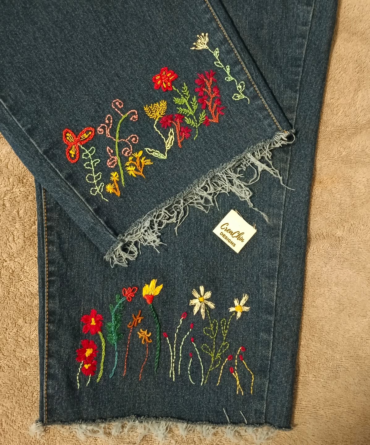 Hand-embroidered flowers on shortened jeans