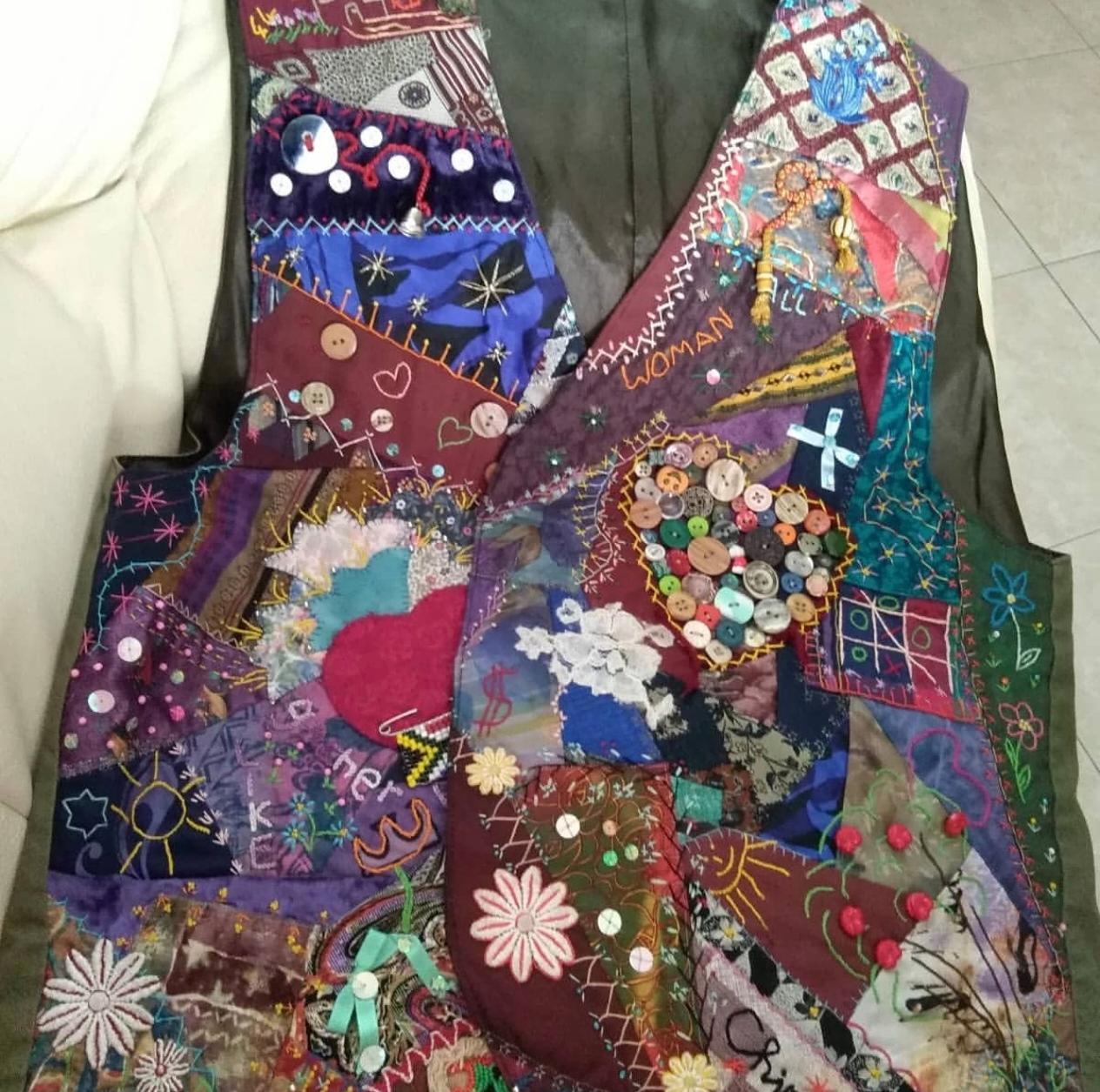 Crazy patchwork waistcoat with hand embroidery, a heart of buttons, a beaded South African flag and a noughts and crosses game